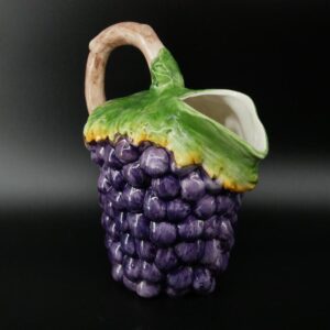 Bassano majolica jug with hand-painted deep purple grapes, green vine leaves, and natural wood handle, front view