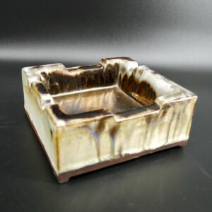 East German ceramic ashtray with cream and brown drip glaze, square form with rolled rim, mid-century studio pottery