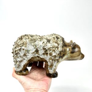 Swedish EGO Stengods ceramic bear, hand-held view showing textured stoneware with whitened patina and warm bronze underglaze
