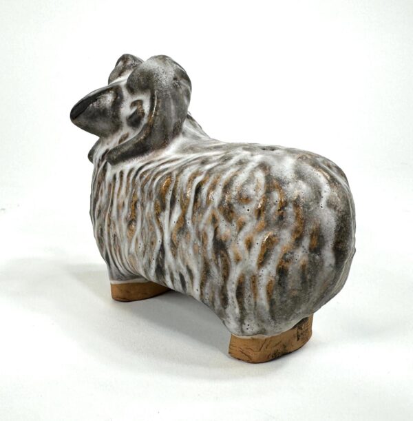 Rear angle of Szilasi pottery sheep showing textured back and wooden foot supports from below