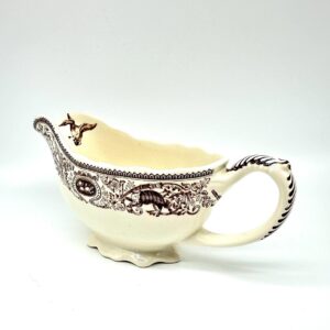 Mason's Patent Ironstone gravy boat in Game Birds pattern, cream with brown transfer decoration, three-quarter front view sho