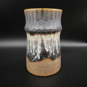German 1960s fat lava ceramic vase with textured gray glaze, cream drip detail, and natural stoneware base