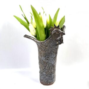 Vintage Scandinavian ceramic rooster vase with textured brown glaze, sculptural head and tail forming rim, holding fresh gree