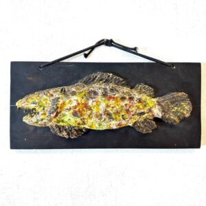 Swedish ceramic fish wall sculpture with yellow and gold glazed textured finish mounted on dark wooden board with rope hanger