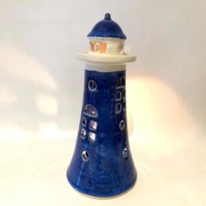 Vintage ceramic lighthouse candle holder, 24cm tall, cobalt blue with cream band and navy dome top, front-facing view