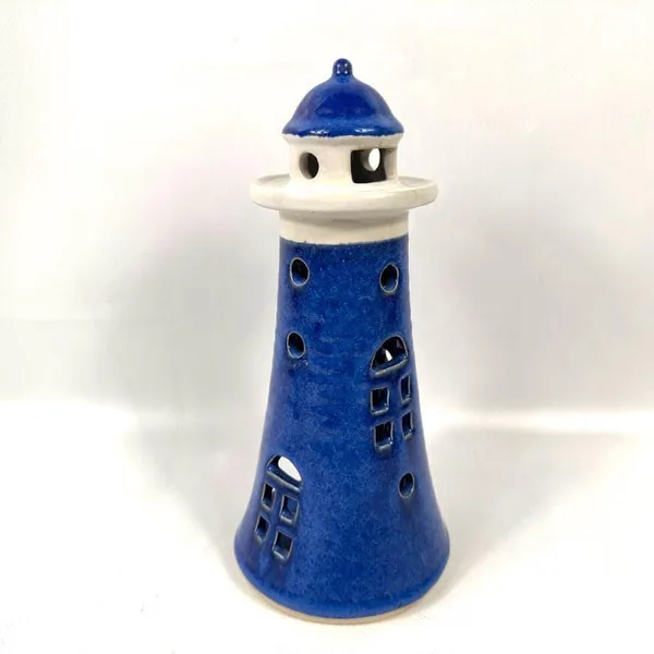 Angled lighthouse holder view emphasizing lantern room dome, cream gallery, and textured tower body proportions