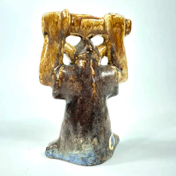 Back view of ceramic figure showing rear arm positioning, base of neck, patina texture, studio marks on bottom