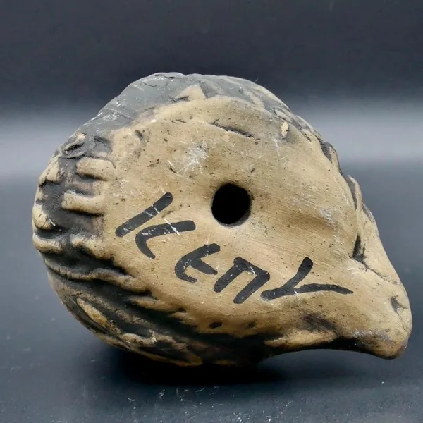 Bottom view of ceramic owl sculpture showing base texture and artist's etched signature Keny with kiln mark details