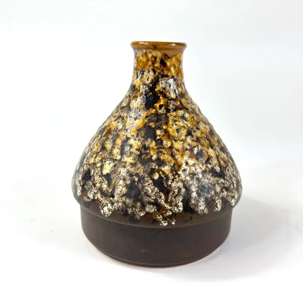 Bulbous lava vase showing front-angled view of golden and silver cratered surface texture