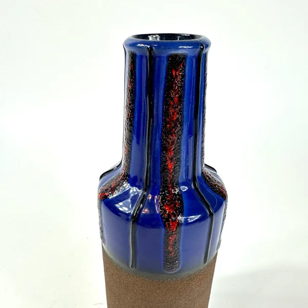 Close detail of vase opening, neck and shoulders displaying cobalt blue glaze pooling, red lava texture, and vertical stripin
