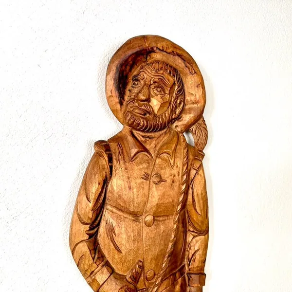 Close-up of Sancho Panza face and hat, showing expressive carved features, beard texture, and period headwear details