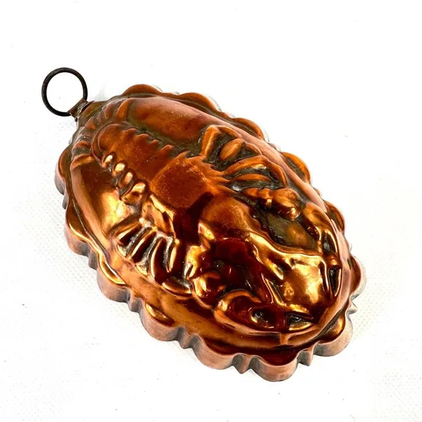 Copper lobster mold profile angle highlighting sculptural depth and burnished copper surface