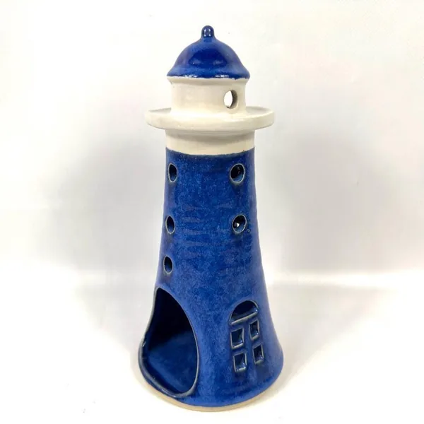 Detailed view of lighthouse body showing double perforations and rich cobalt patina with cream trim accent