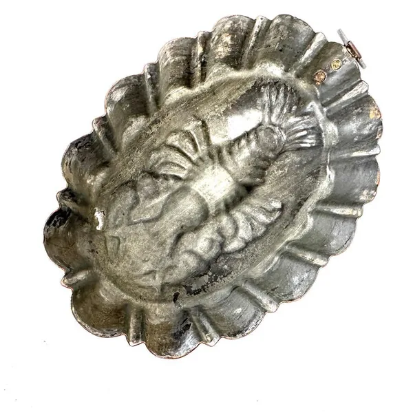 Detailed view of lobster relief carving showing shell texture and sculptural features in silver patina
