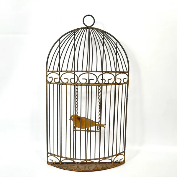 Direct frontal view of metal birdcage showing symmetrical wires, ornate band pattern, and centered brass bird hanging