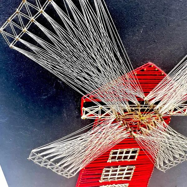 Extreme close-up of string art blade threads, brass center hub, radial tension and craftsmanship