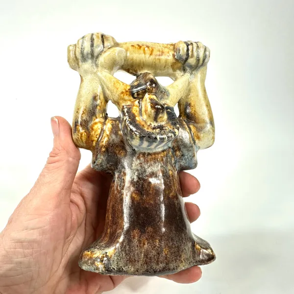 Final held view of ceramic Viking figure displaying complete golden arm glaze, detailed face, full stoneware body