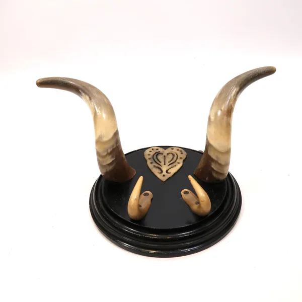 Finished view of vintage Scandinavian horn rack showing complete assembly with natural bull horns, bone heart carving, and mo