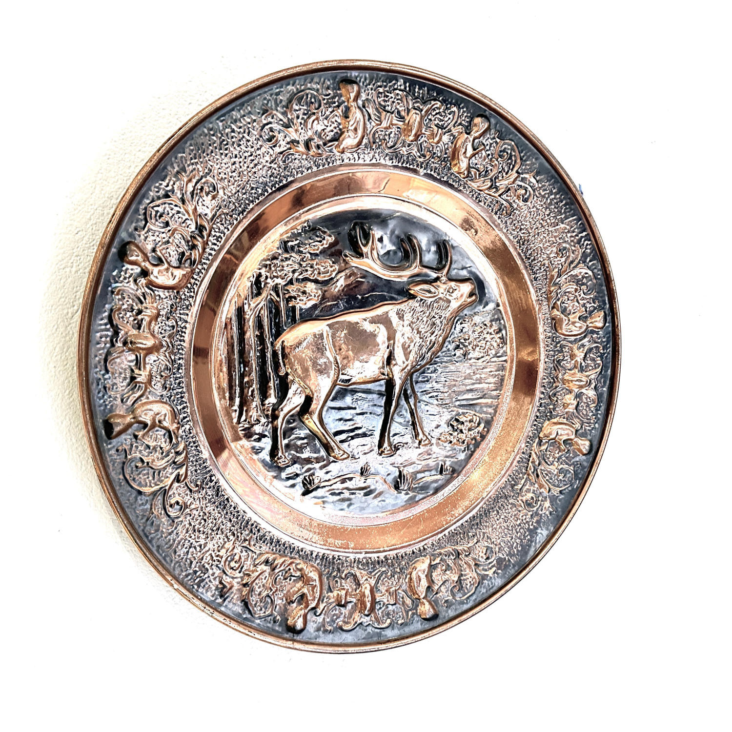 Full front view of copper stag plate showing complete composition with oxidized patina and warm copper highlights