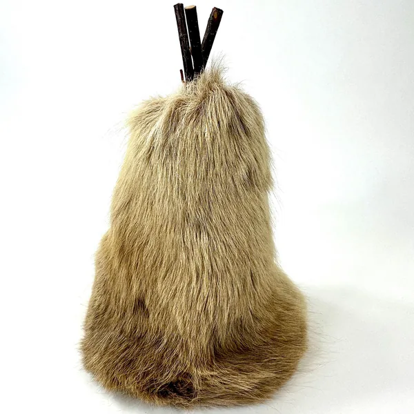 Full-length view of reindeer skin teepee from rear showing tapered cone shape, natural fur pile, and vertical wood frame line