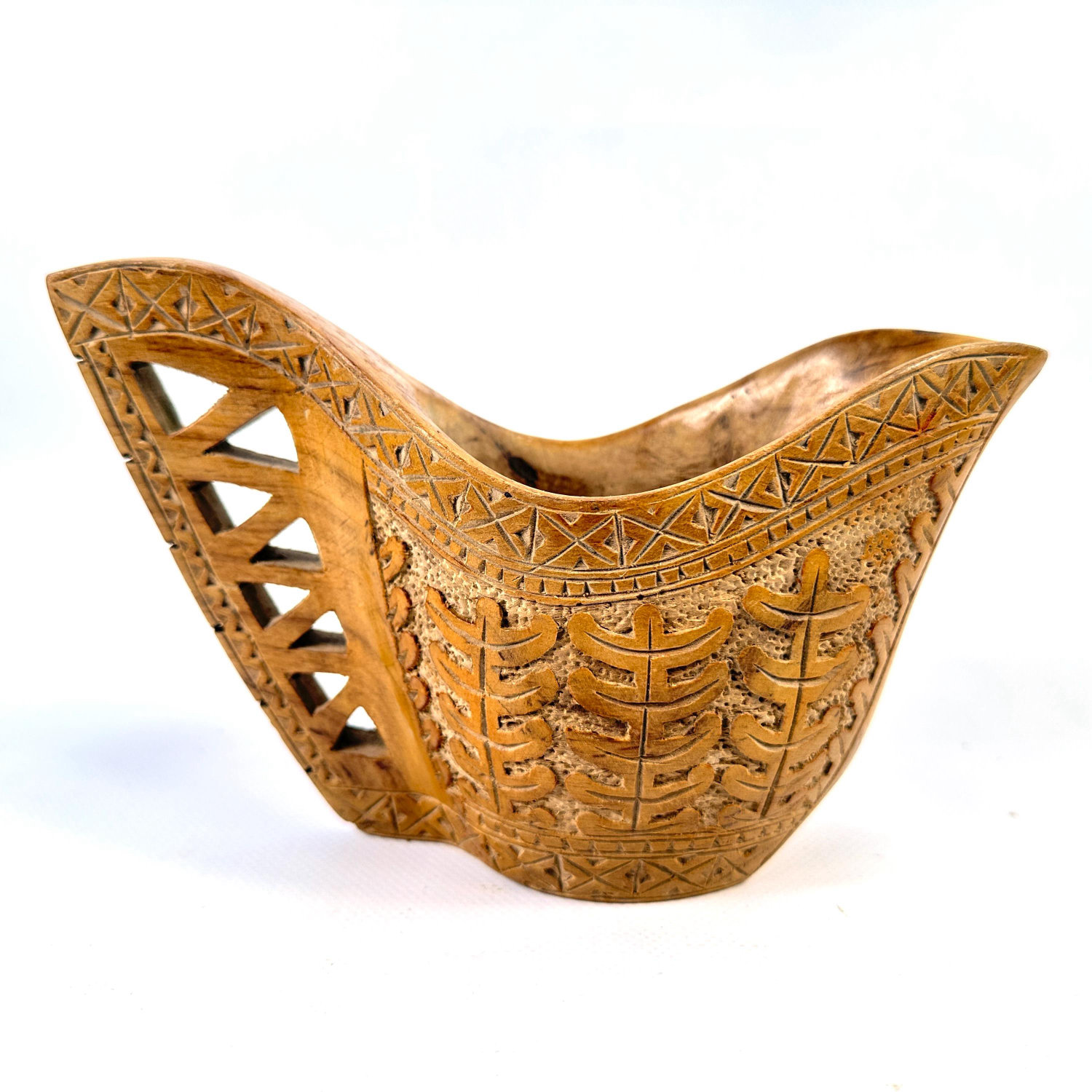 Hand-carved Balkan wooden shepherd's cup with geometric cutwork, triangular handle openings, and botanical relief carving thr