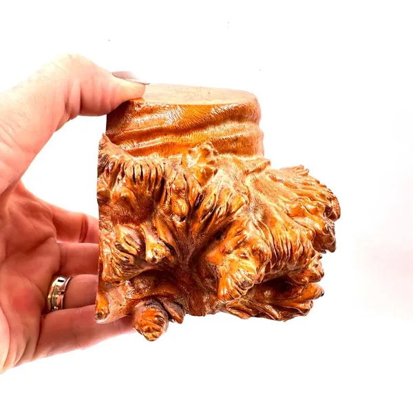 Held bookend in hands showing full dimensional form, carved surface patterns, wood grain richness, and vintage craftsmanship