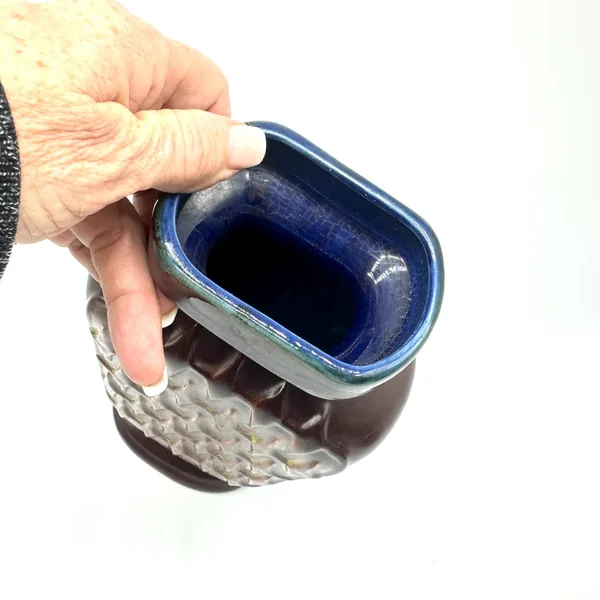 Interior opening of Scheurich vase displayed in hand, showing glossy cobalt-blue rim glaze and pale ceramic interior surface