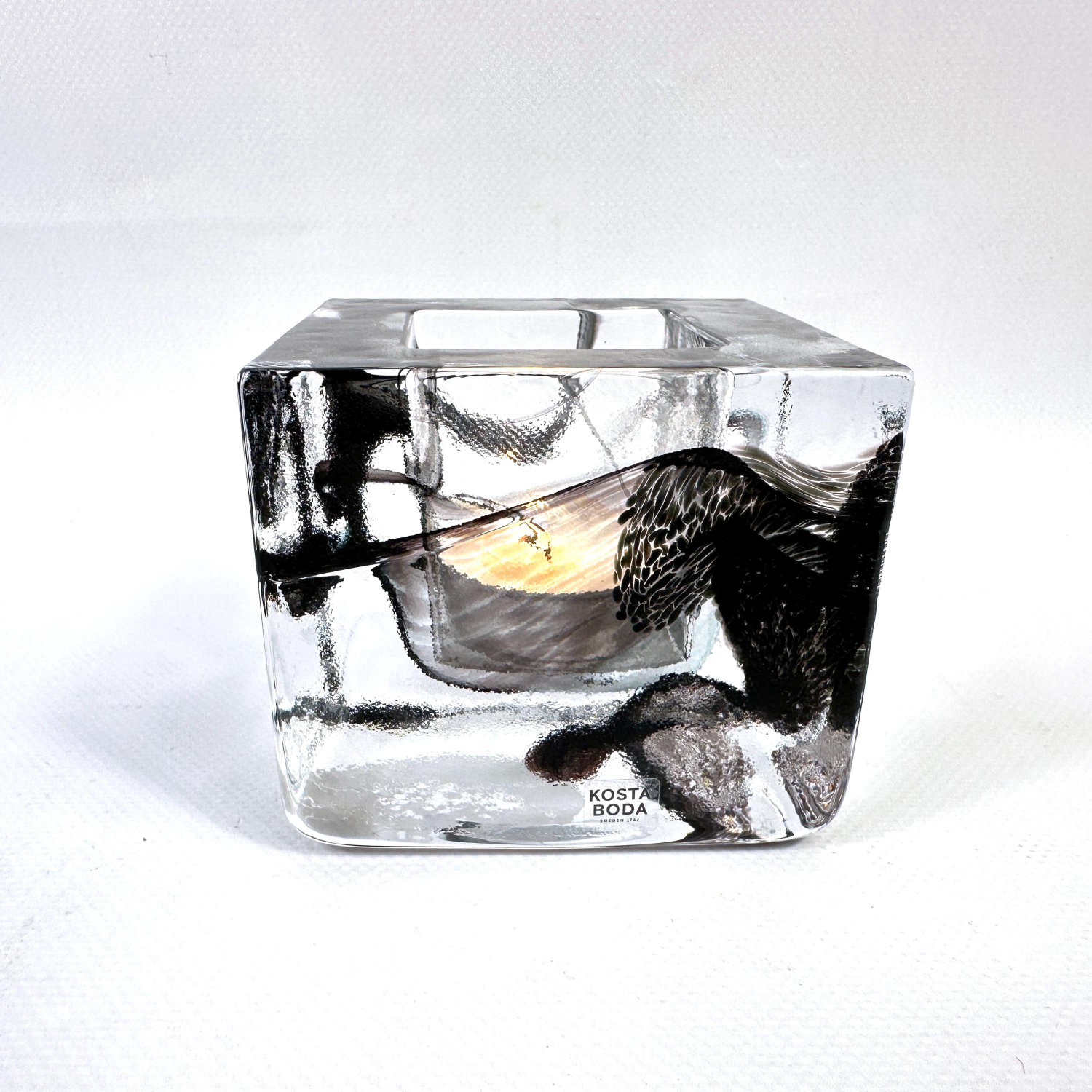 Kosta Boda Brick glass votive holder by Anna Ehrner, black ice block with embedded geometric forms, front view