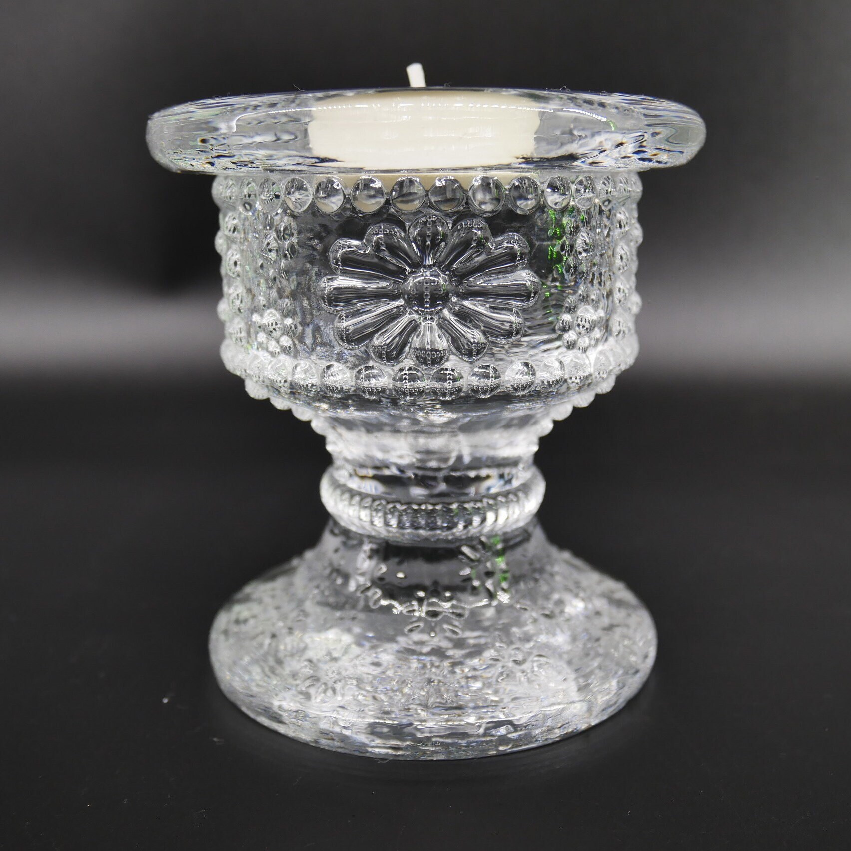 Kosta Boda Daisy candlestick by Rolf Sinnemark, clear textured art glass with pressed flower pattern, pedestal base