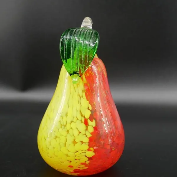 Kosta Boda glass pear side profile showing bold red section, citrine body, and clear glass stem detail