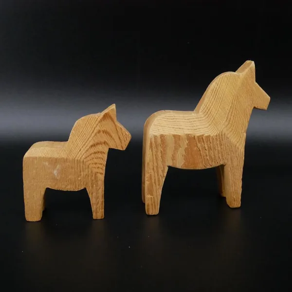 Larger Dala horse in isolation showing full height and arched neck posture, wood finish detail visible throughout