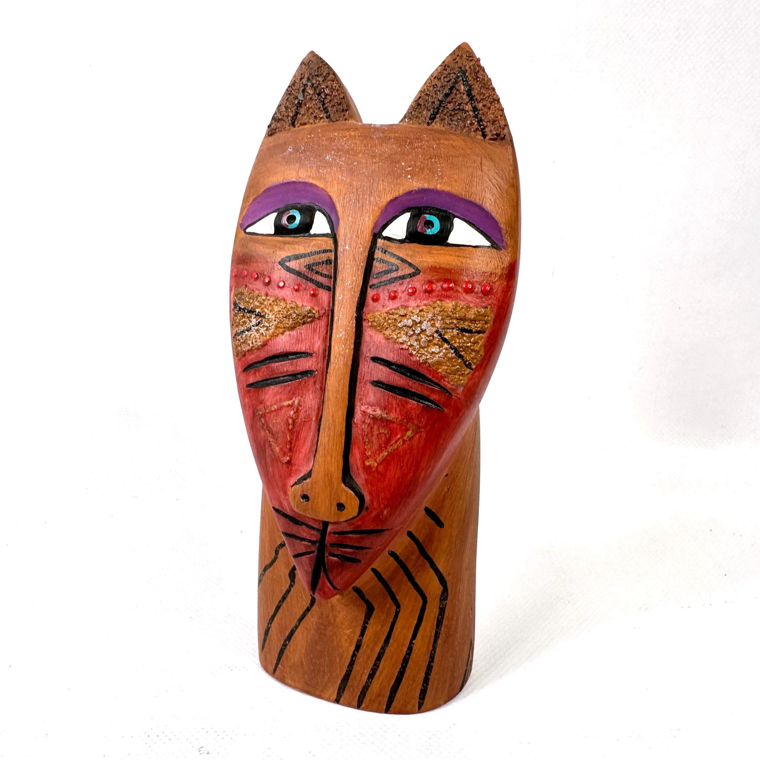 Laurel Burch cat sculpture with pointed ears, purple-rimmed eyes, red painted face with gold accents, and carved line details