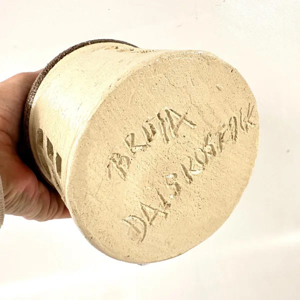 Maker's mark carved into ceramic base, Brita Dals signature, Rostocks Sweden pottery stamp, aged cream stoneware underside