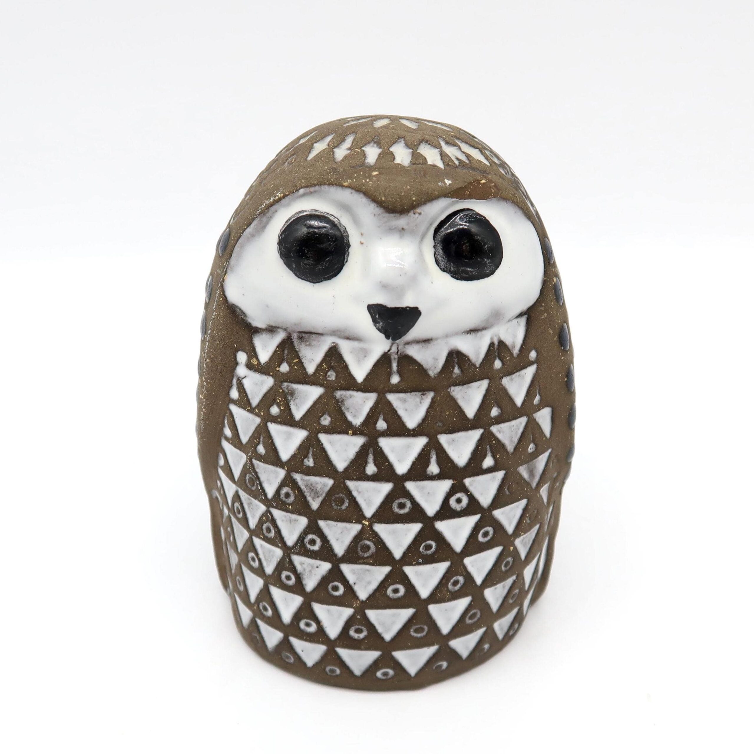 Mari Simmulson ceramic owl figurine, brown stoneware with geometric triangle pattern, white face and black eyes, front view
