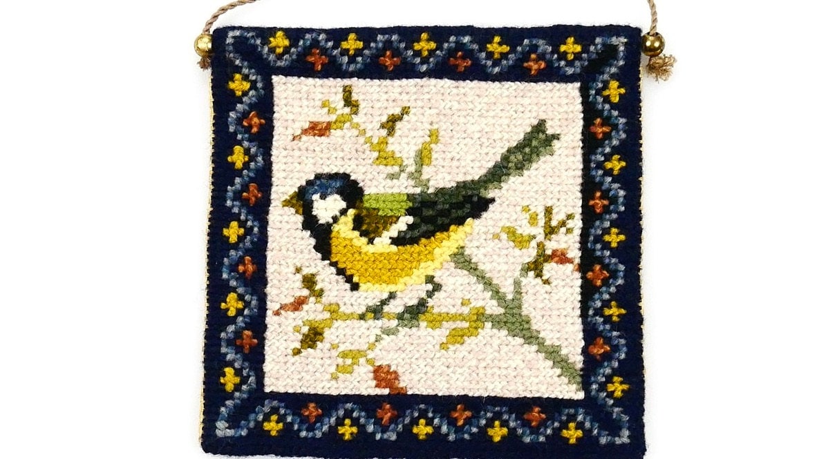 Mid-century blue tit tapestry with hand-embroidered wool bird on cream linen, navy geometric border, brass hanging rod