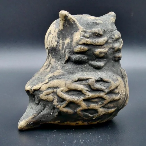 Opposite profile angle of ceramic owl displaying sculpted contours, layered feather carving, and natural patina of aged glaze