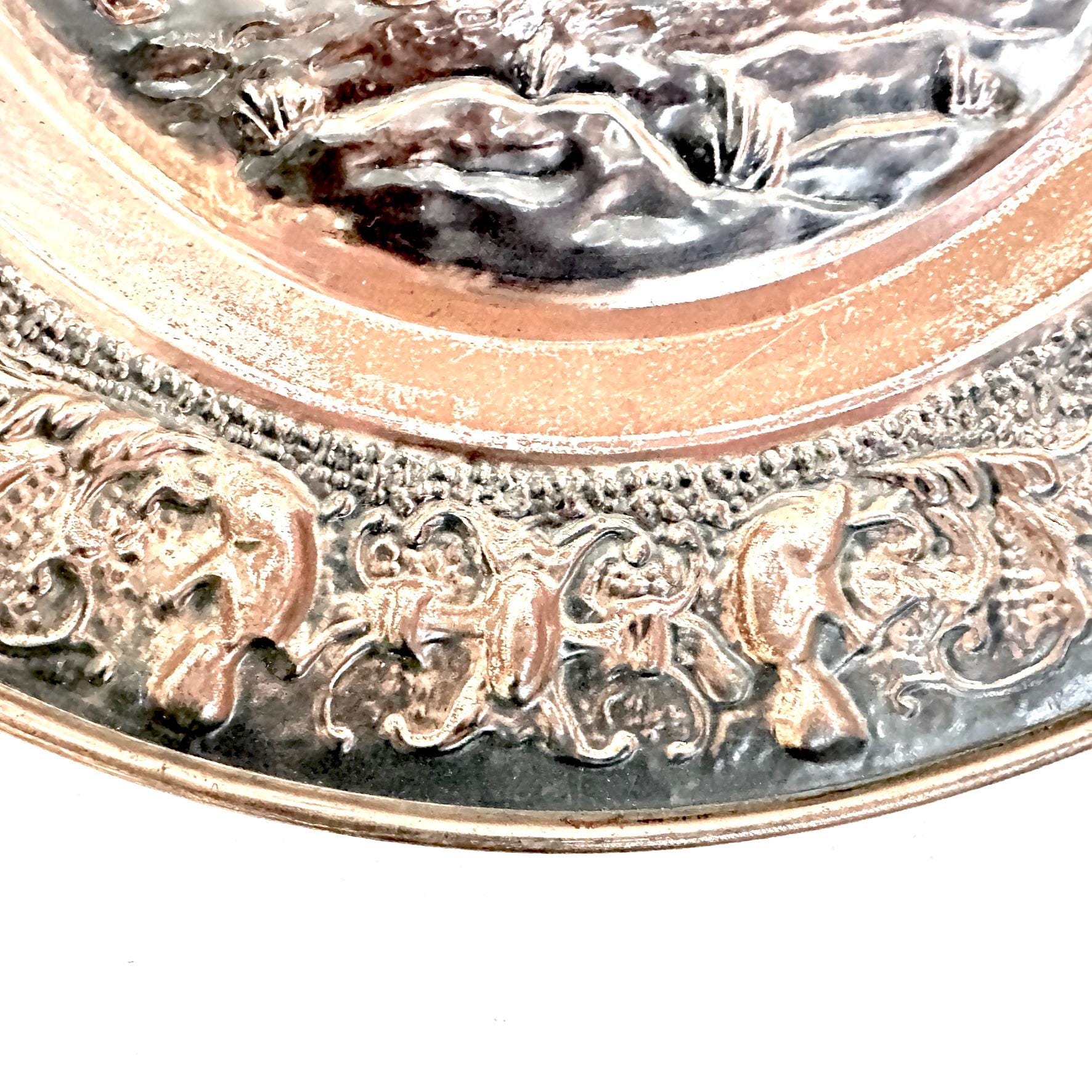 Ornamental border detail with scrolling foliage and decorative elements surrounding central stag medallion