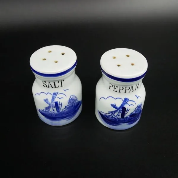 Overhead angle showing both shaker caps with perforated ceramic lids, highlighting functional design and hole patterns