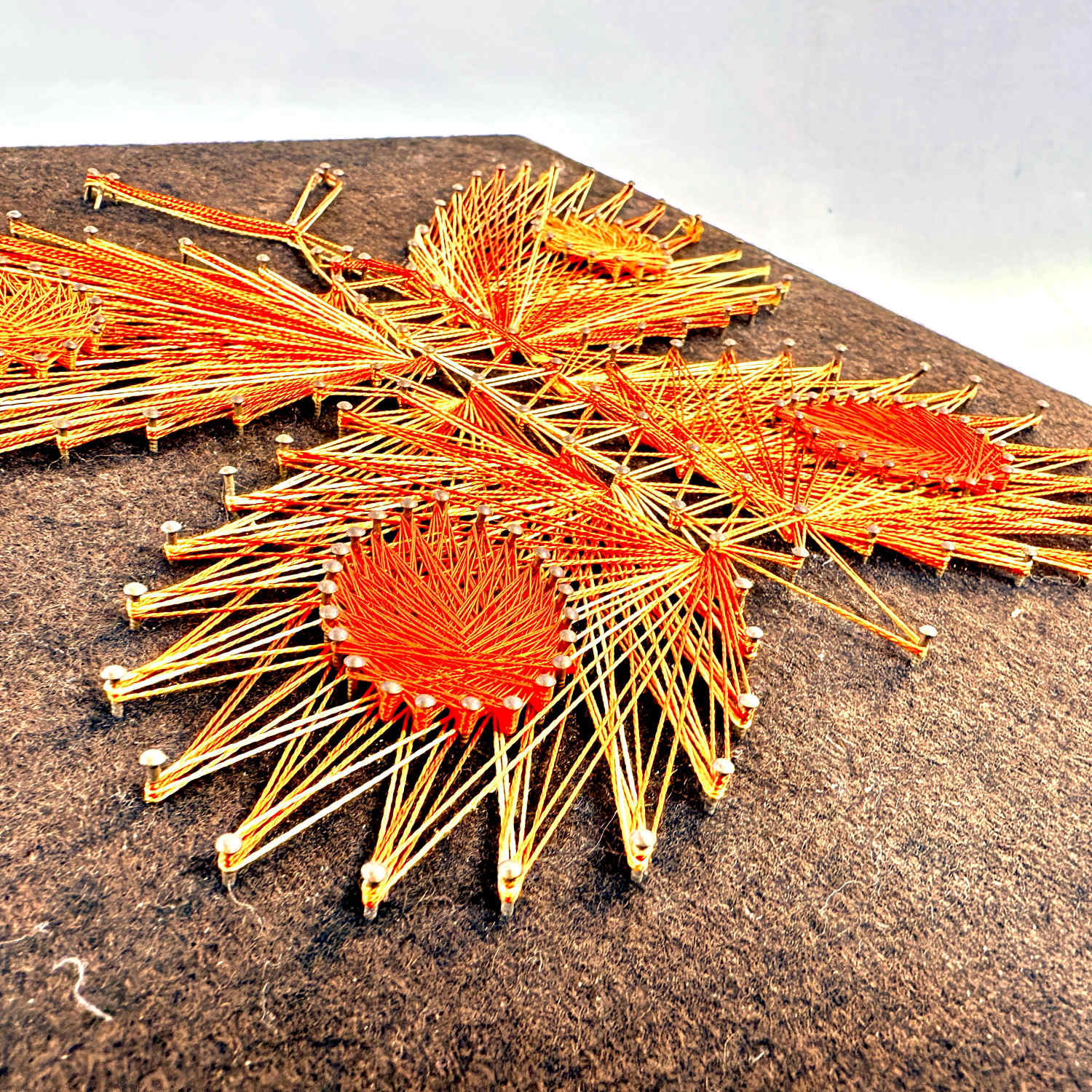 Overhead angled view of butterfly string art showing complete design with texture and dimensional threads