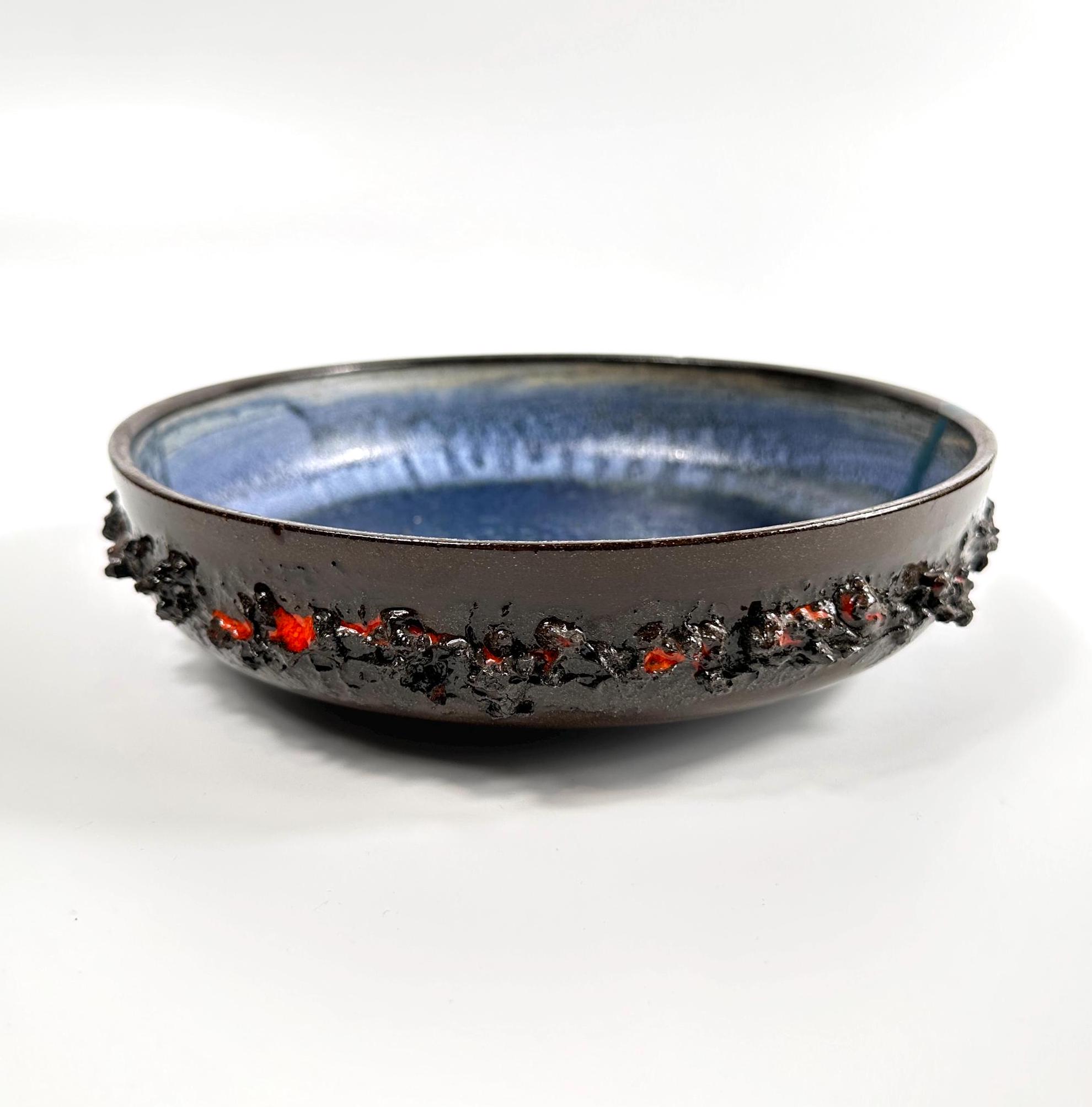 Overhead view of vintage Glit Iceland lava bowl showing full blue interior glaze and decorative textured rim detail