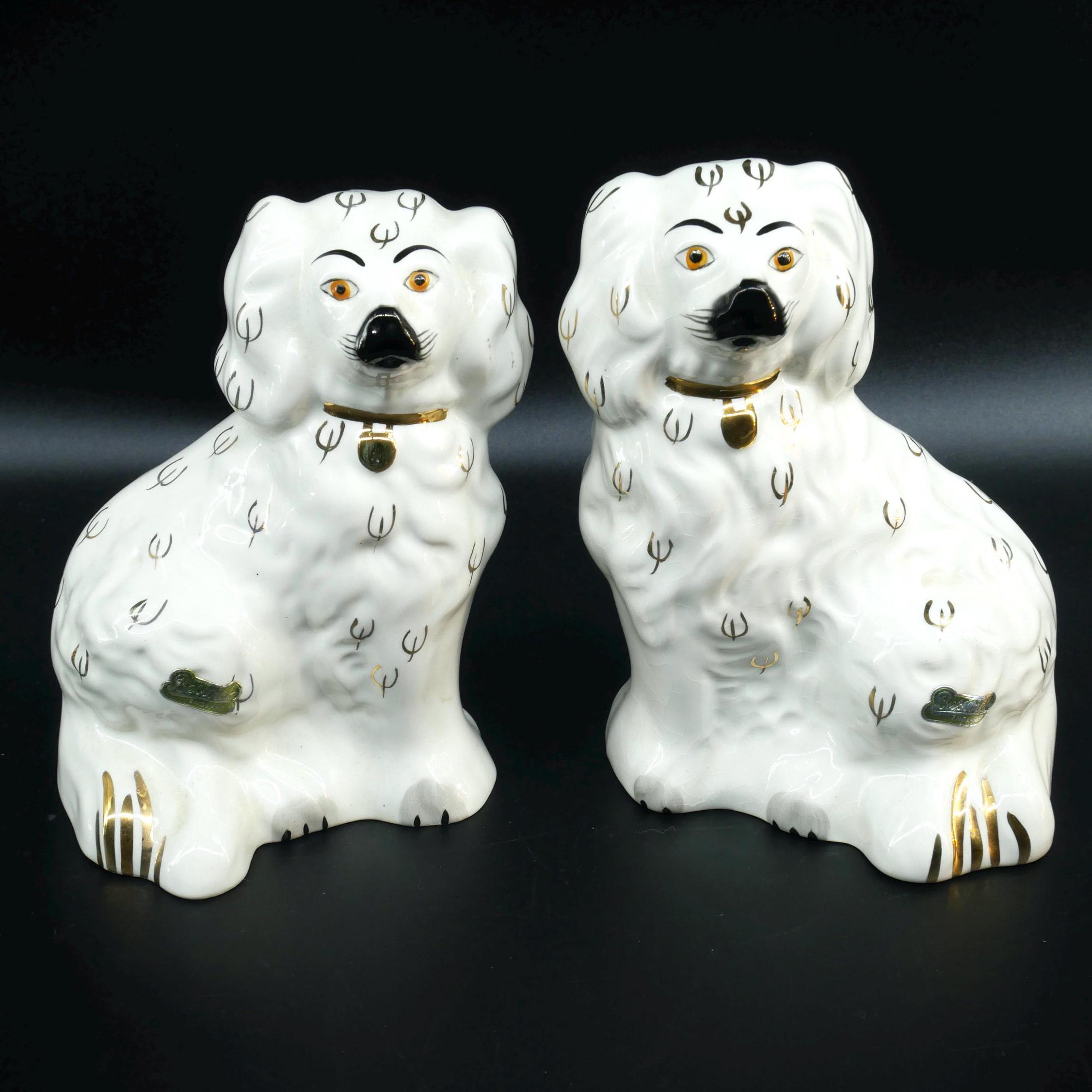 Pair of Beswick King Charles Spaniel figurines, cream ceramic with hand-painted black facial features and gold collar details