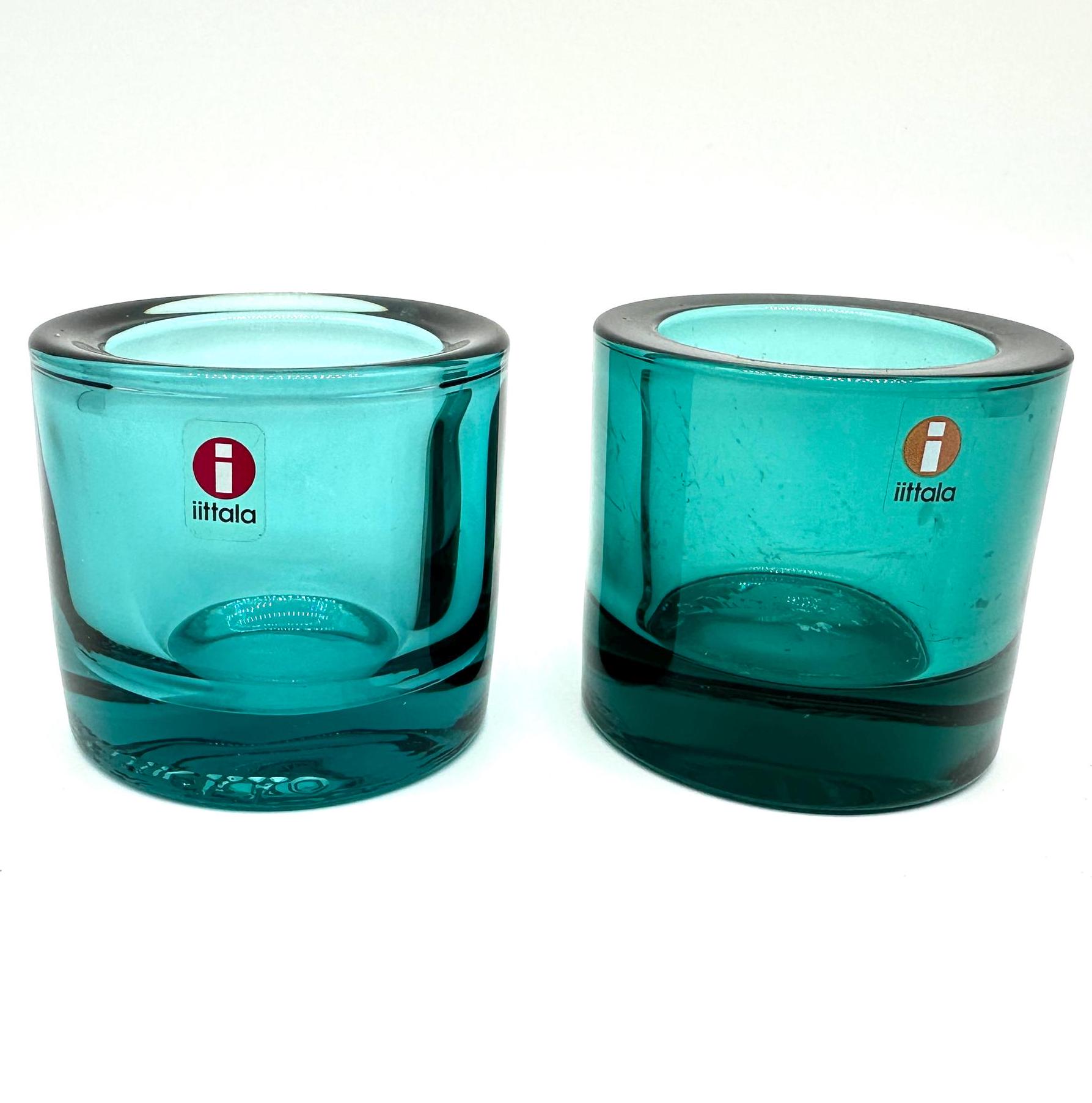 Pair of Iittala Kivi tealight holders in translucent turquoise glass with thick walls and recessed bases, Finnish design
