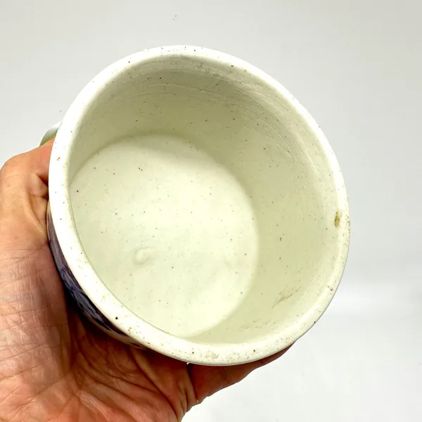 Porcelain jar interior surface, unglazed cream ceramic, visible texture and patina of vintage piece