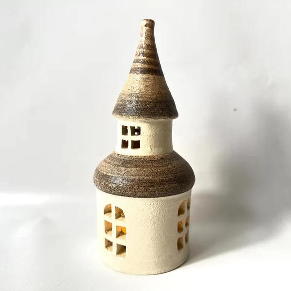 Rectangular window openings arranged on cream ceramic tower, hand-painted details visible, textured glaze finish, architectur