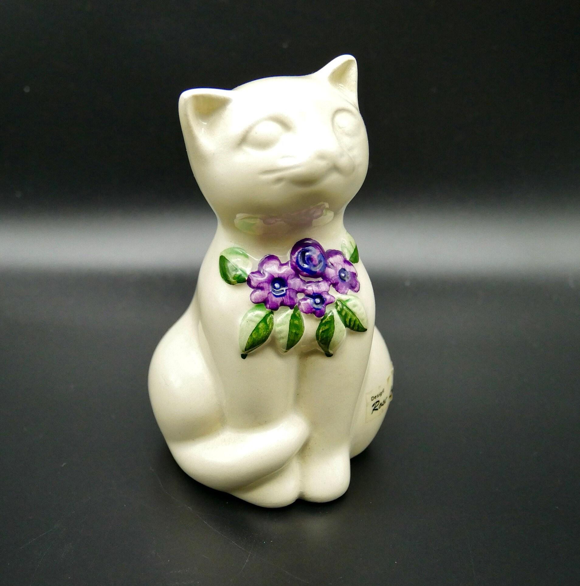 Rosa Ljung ceramic cat figurine, cream white with hand-painted purple flowers and green leaves, Swedish 1970s, front-facing s