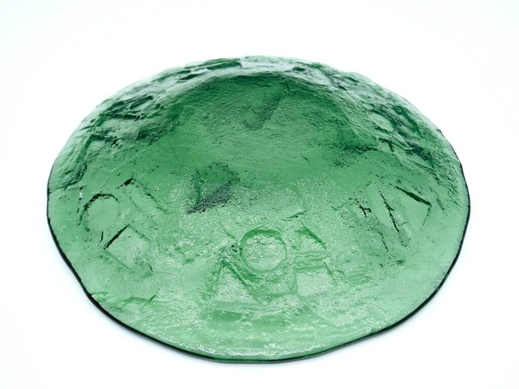 Ruda vintage green glass plate angled detail showing embossed surface texture and glass depth
