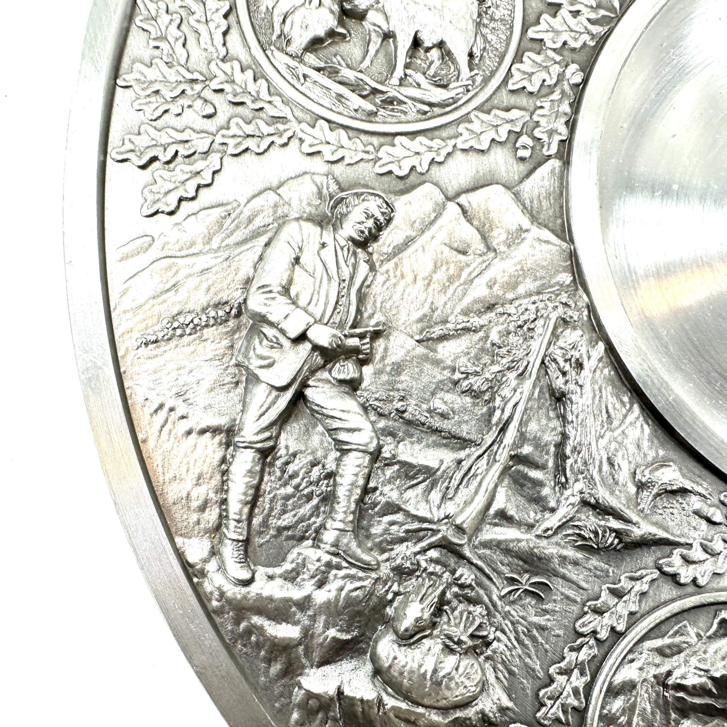 Side profile detail showing relief figure with hunting implement among detailed vegetation and textured background work