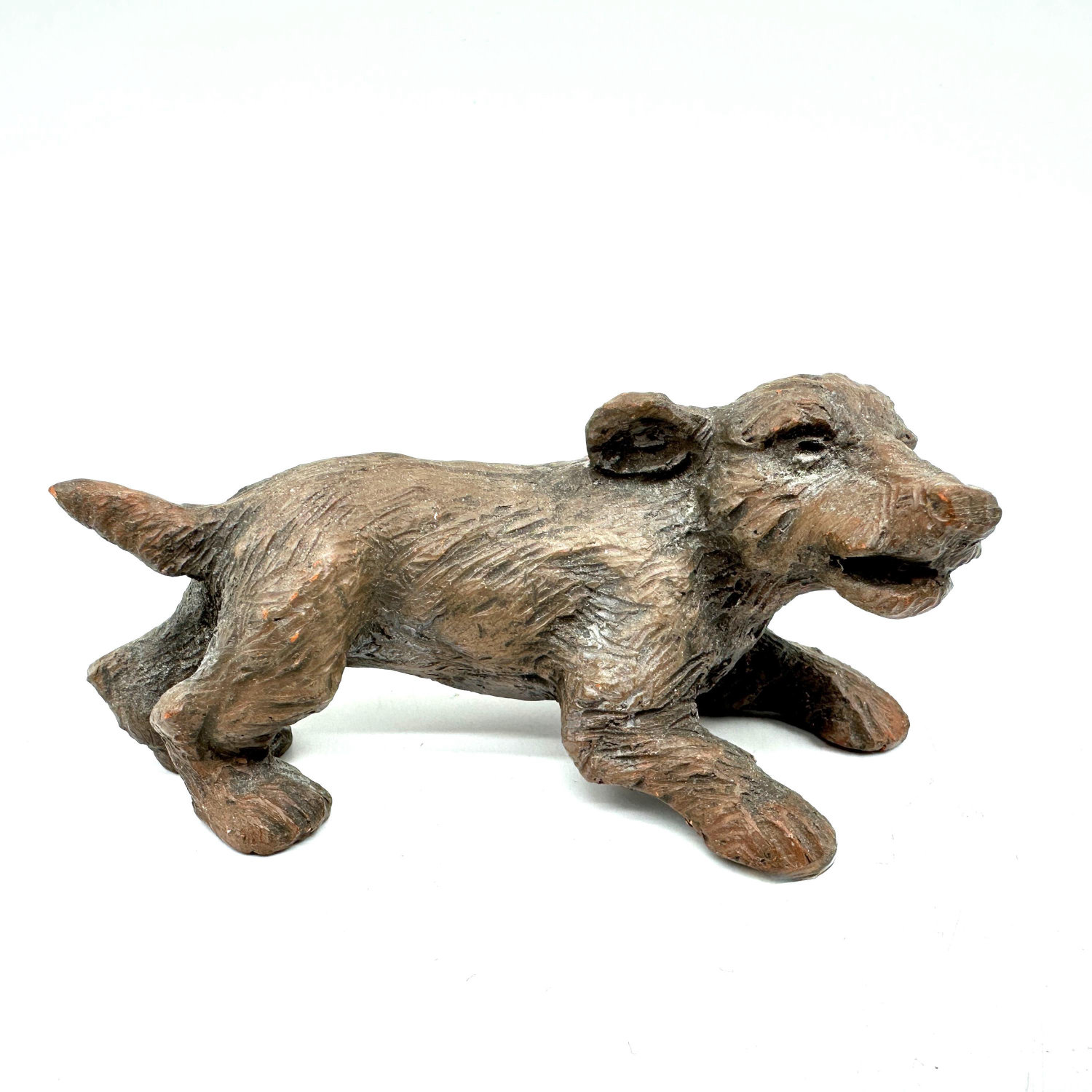 Signed Scandinavian studio pottery dog with stretched body, expressive face, earthy textured surface, side profile view