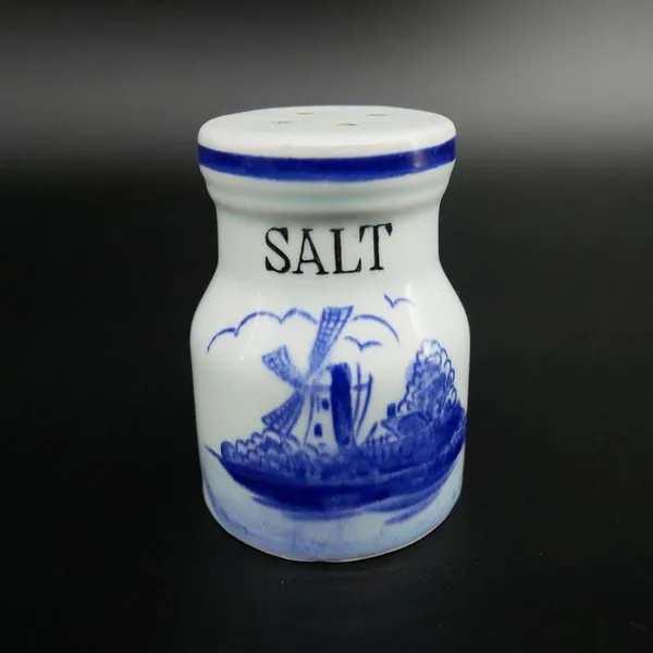 Solo salt shaker in cream ceramic with blue rim, showing curved silhouette and hand-painted windmill detail