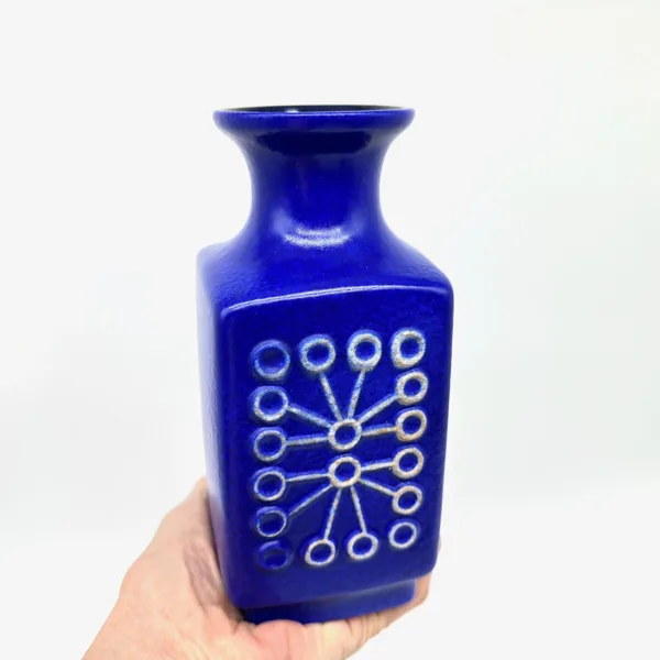 Sputnik vase held in hand showing scale, weight presence, and glazed surface finish texture